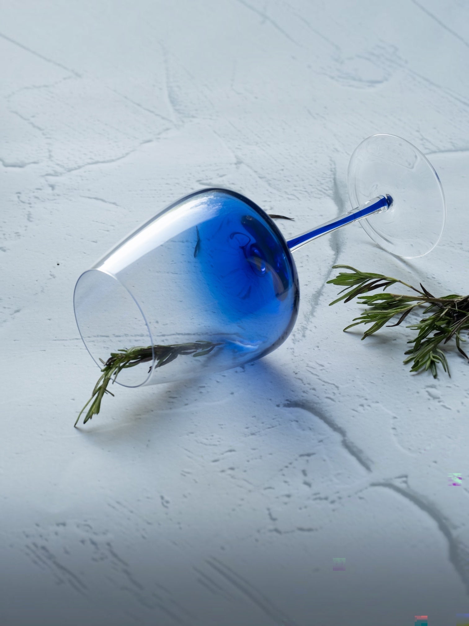 INVOKE elegant blue tinted wine glass with clear stem and base, featuring a gradient from deep blue to clear.