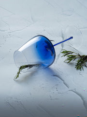 INVOKE elegant blue tinted wine glass with clear stem and base, featuring a gradient from deep blue to clear.