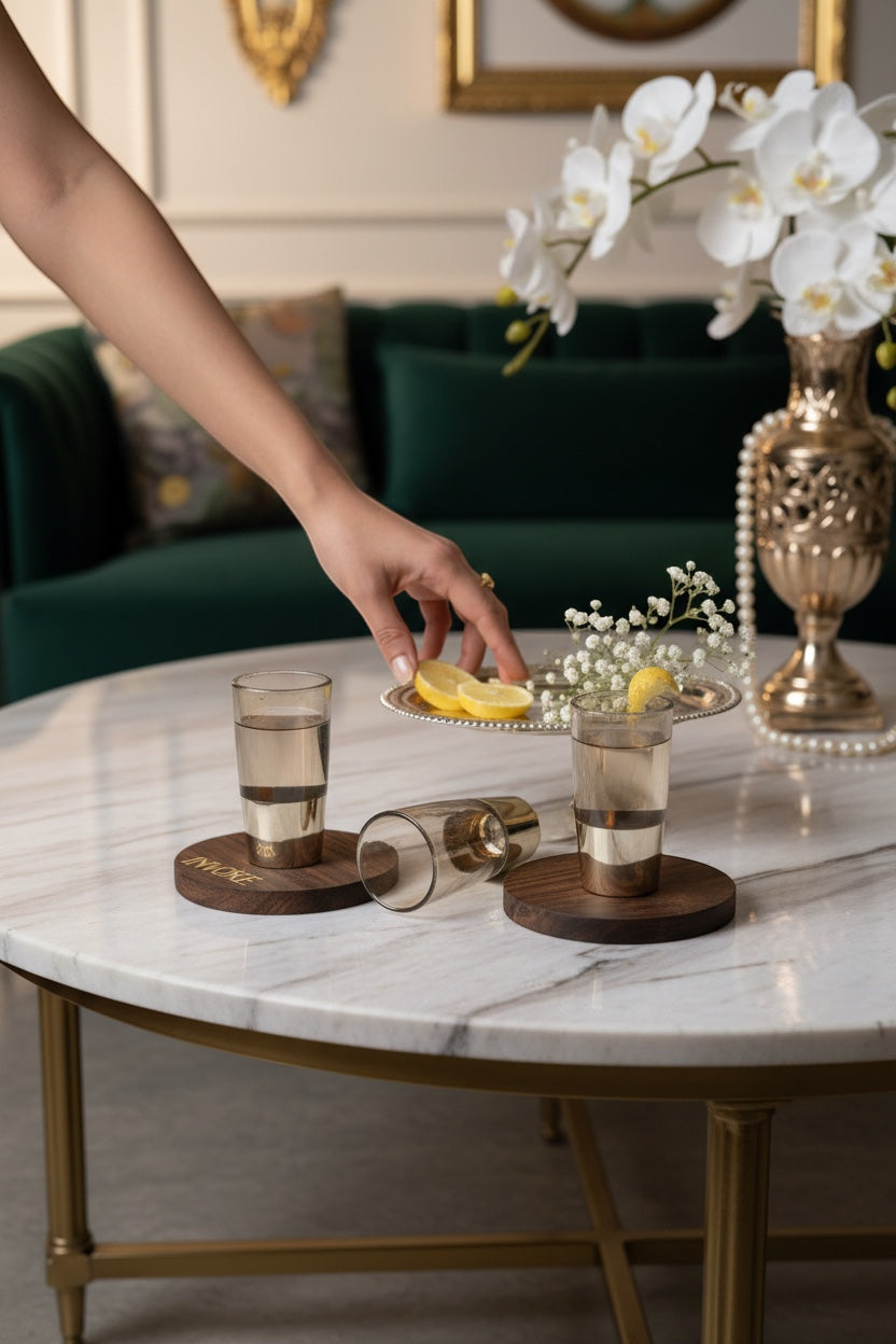INVOKE Cabo White Rum With Coconut Liqueur in smoked glass, served with lemon slices on wooden coasters.