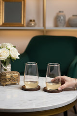 INVOKE Clario High Ball Glass with tapered design and substantial base, made of clear glass. Two glasses on a marble table.