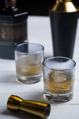 INVOKE Etched Leaf Pattern Lowball Whiskey Glasses Set with ice and whiskey.