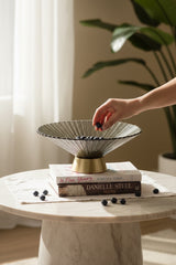 Invoke Home and Living large round platter in smoky grey textured glass with a brushed gold base, styled with blueberries on books.