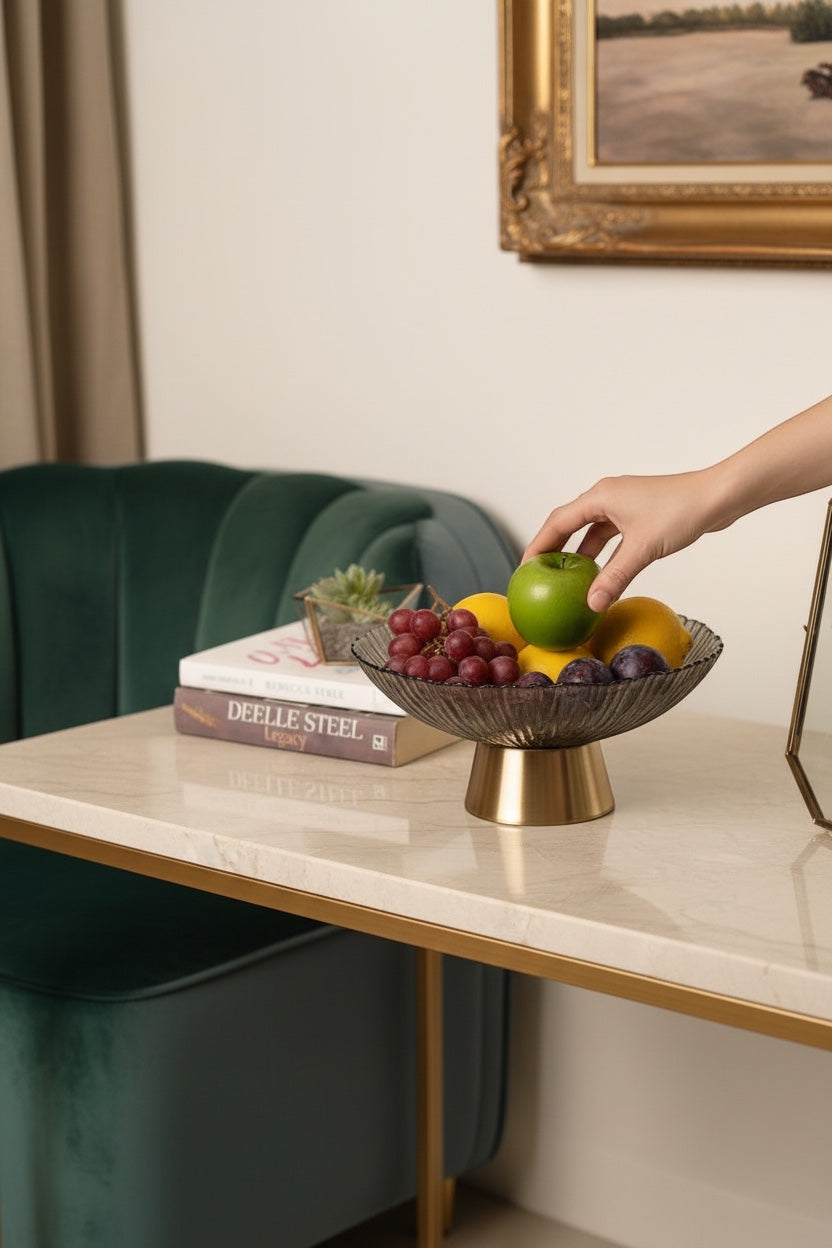 Invoke Home and Living small round platter in smoky grey textured glass with brushed gold base, holding fruit.